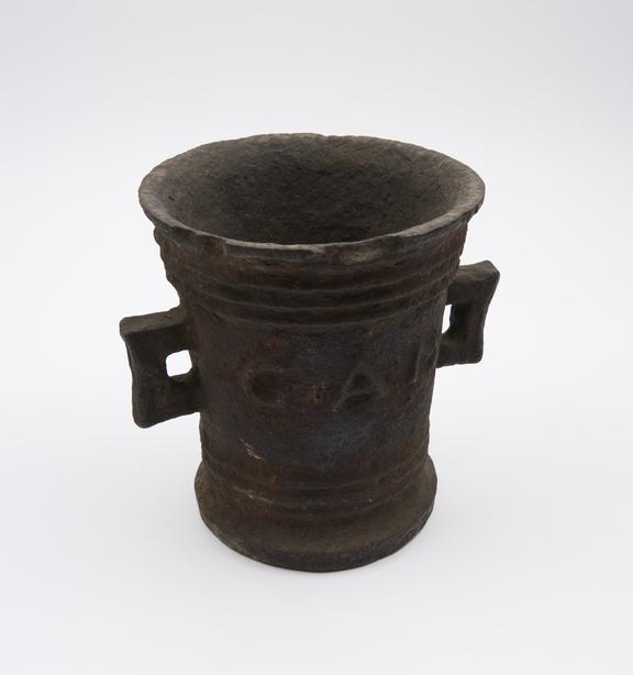 Tall thin iron mortar, slightly flared rim