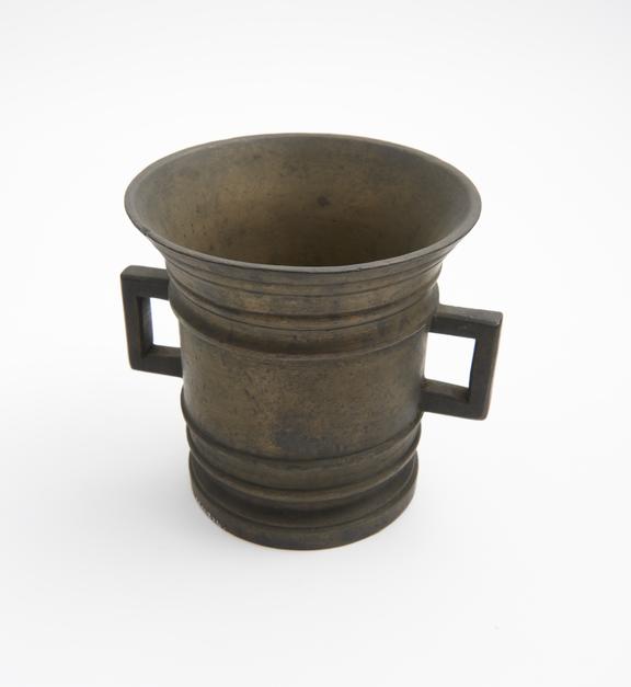 Tall brass mortar with fairly straight sides, flaring rim,