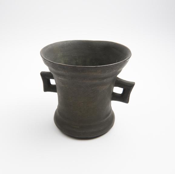 Bronze mortar, concave sides, flared rim and foot, flat base