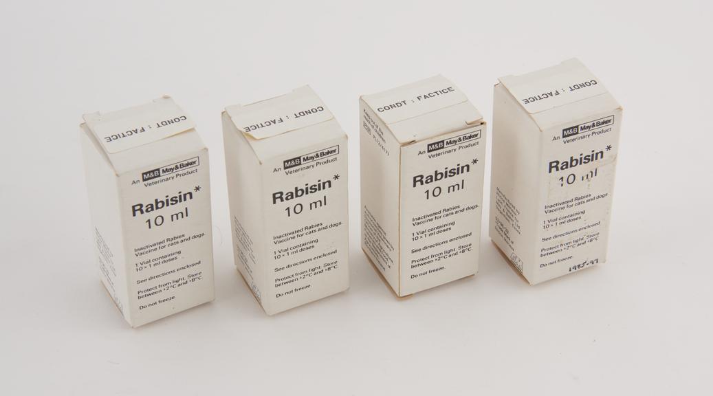 Four bottles containing Rabisin' rabies vaccine for animals