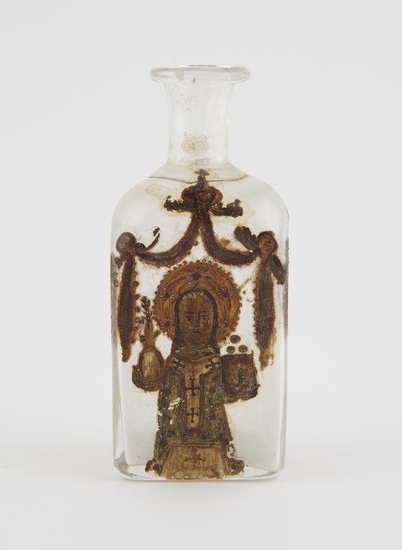 Glass bottle with Saint painted on side