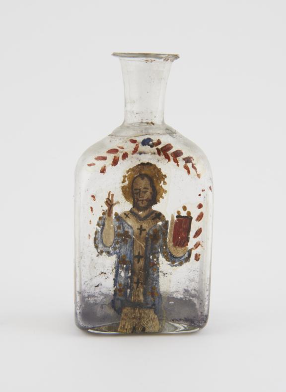 Glass bottle with picture of Saint painted on side