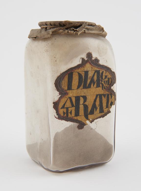 Glass jar containing unidentified drug