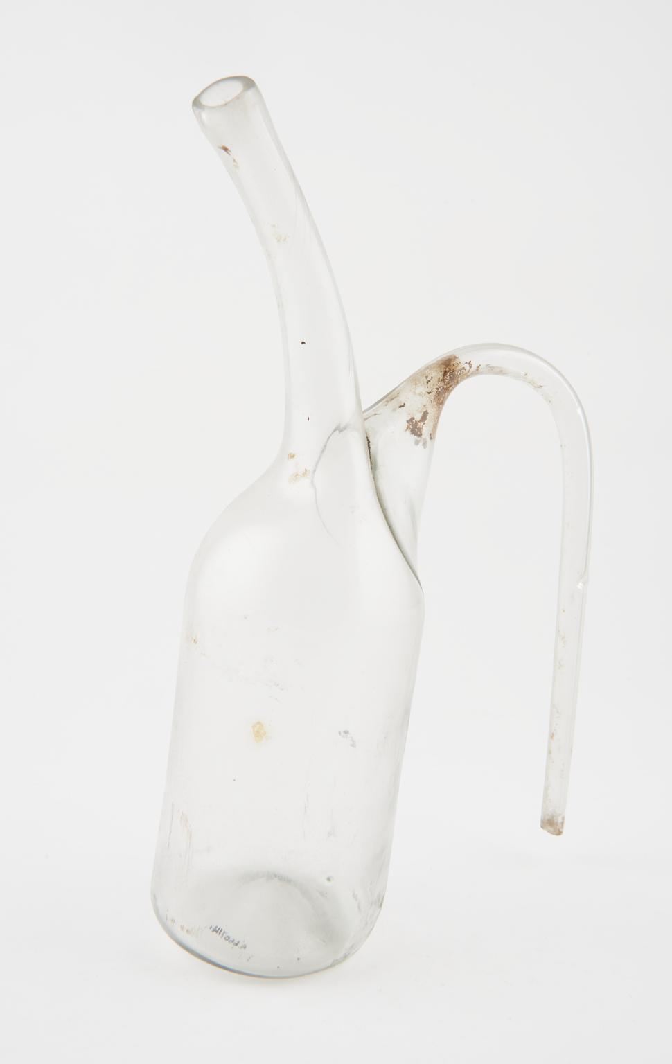 Glass flask, one of two, with long curved spout