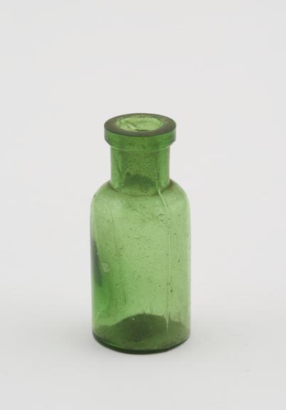 Green glass bottle with narrow neck and ground clear glass stopper with pontil