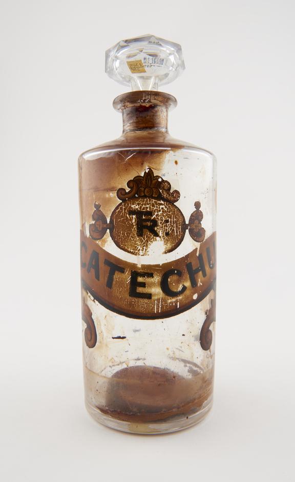 Bottle, clear glass, with contents, for tincture of catechu