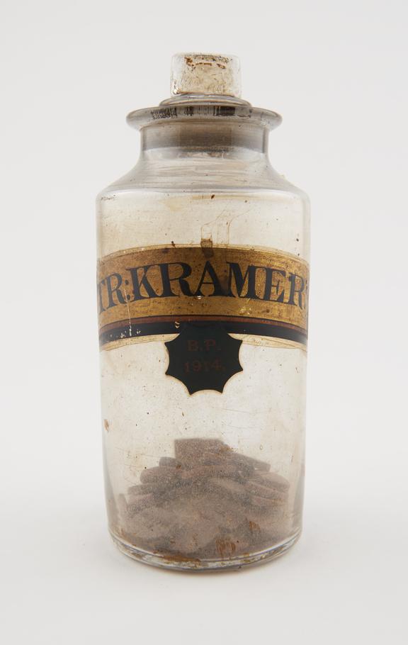 Bottle, cler glass, for krameria tablets, with contents