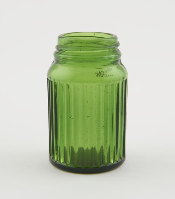 Small green glass jar with ribbed body