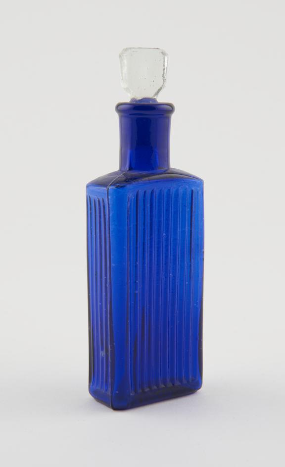 Glass poison bottle, blue, rectangular, with three ribbed sides