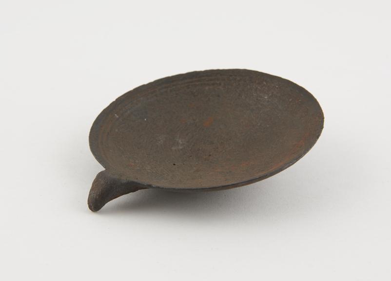 Shallow saucer, iron, C18 or C19, possibly used as a crucible