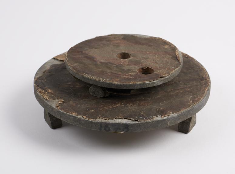 Lead disc with three feet, paper covering