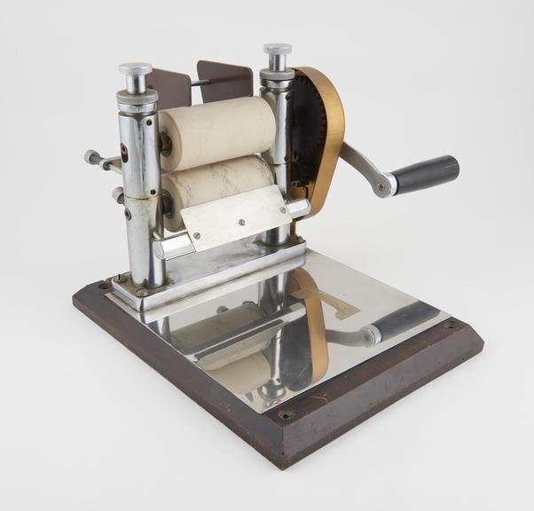 Mass roller on wooden base for rolling out paste for pills and