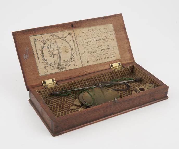 Apothecary's balance with steel beam and brass pans in wooden