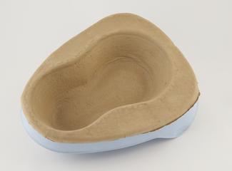 Cardboard bedpan associated with 'Vernacare 750' cold water disposal unit for bedpans