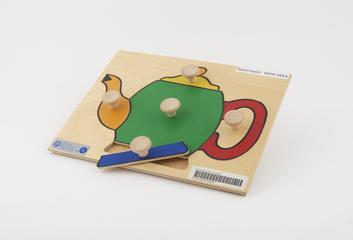 Wooden puzzle board showing a teapot
