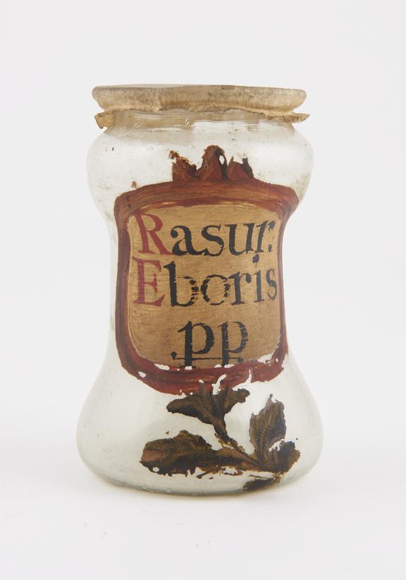 Glass albarello, with parchment cover, labelled Rasur