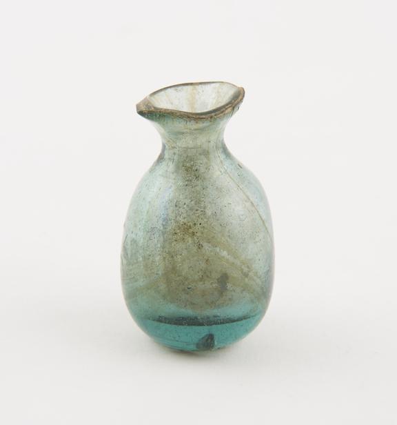 Cylindrical iridescent green glass bottle with lip