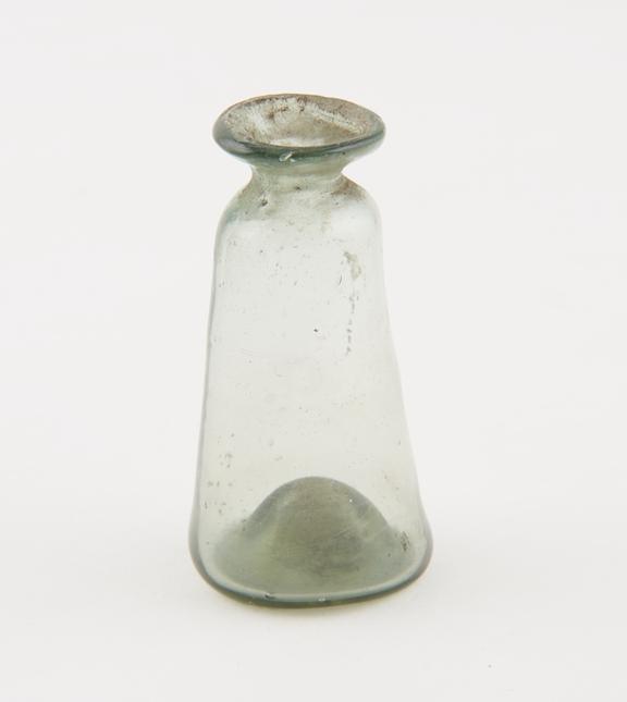 Small green glass bottle, conical shaped body