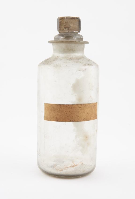 Bottle, clear glass, with contents, English, late 19th century