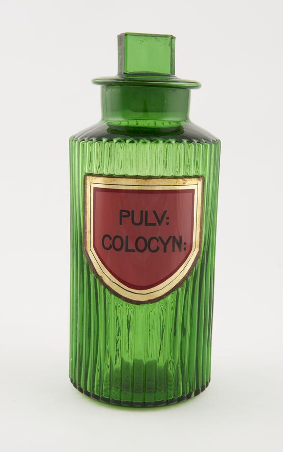 Shop round, glass-fronted label PULV:COLOCYN (Colocynth powder)