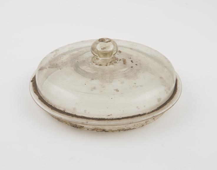 Flat glass lid, perhaps from Italian pharmacy display jar