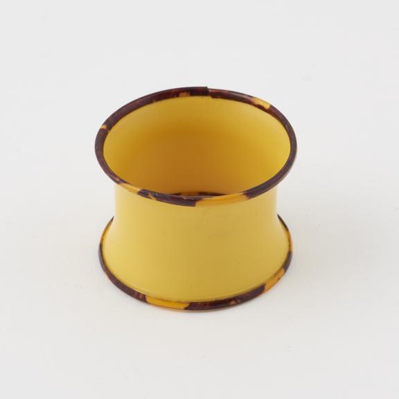 Napkin ring of yellow cellulose nitrate trimmed with