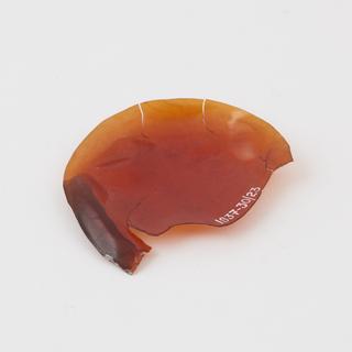 Damaged sample of transparent orange parkesine