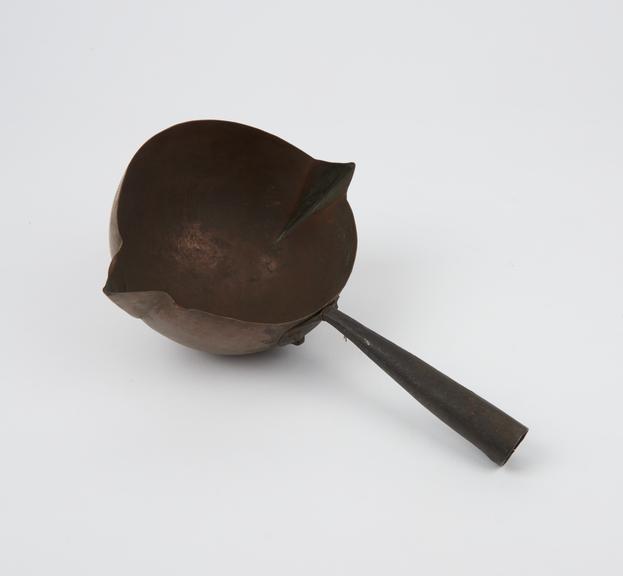 Copper ladle with rounded bowl and tubular handle