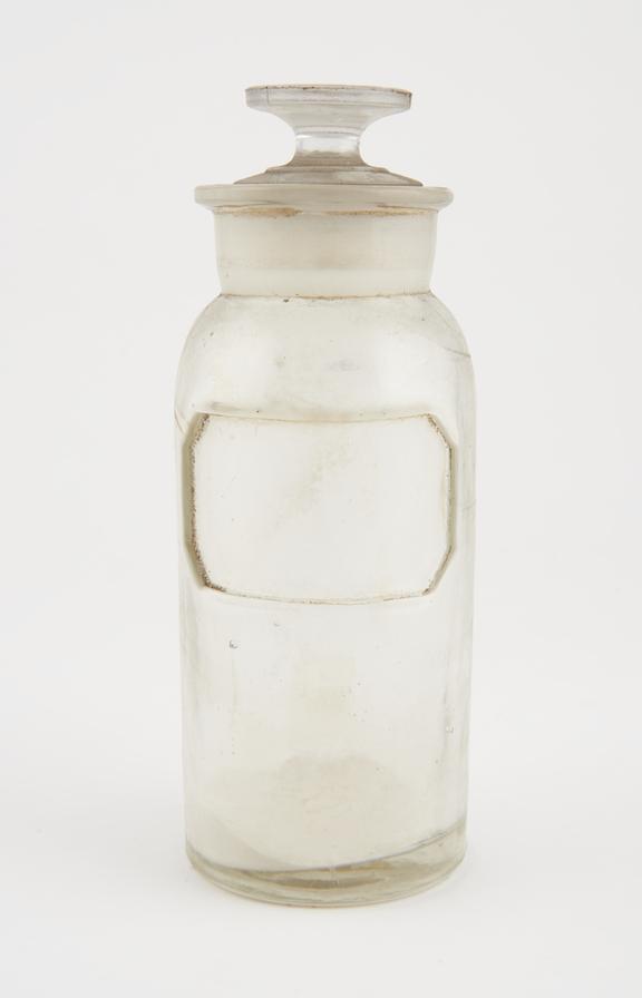 Bottle, clear glass, with contents