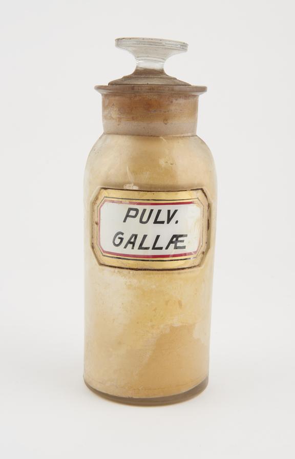 Bottle, clear glass, with contents, for powdered galls, USA