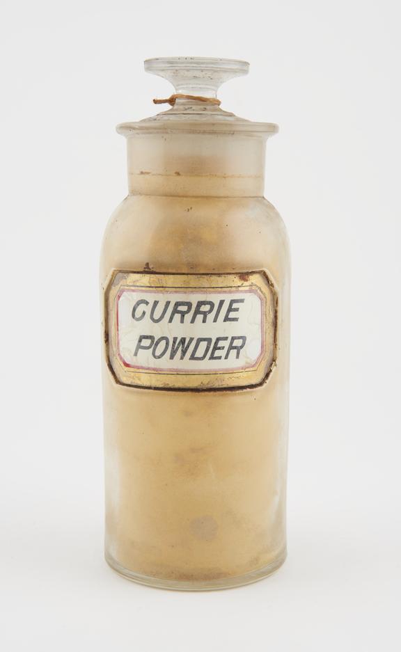 Bottle, clear glass, with contents, for curry powder, USA