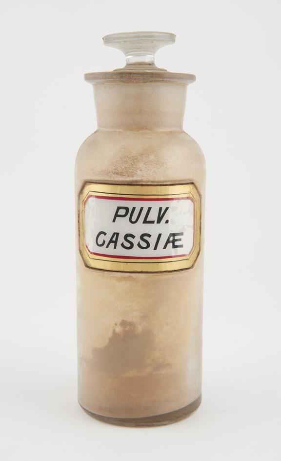 Bottle, clear glass, with contents, for powdered cassia, USA