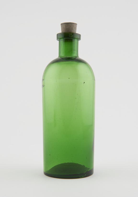 Small green glass, dispensing bottle with rubber stopper