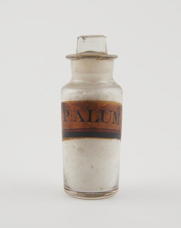 Bottle, clear glass, with contents for powdered alum, English