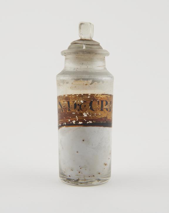 Bottle, clear glass, with contents, for grey powder, English