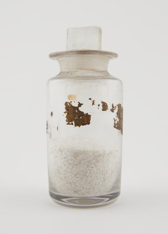 Bottle, clear glass, with contents, English, late 19th century