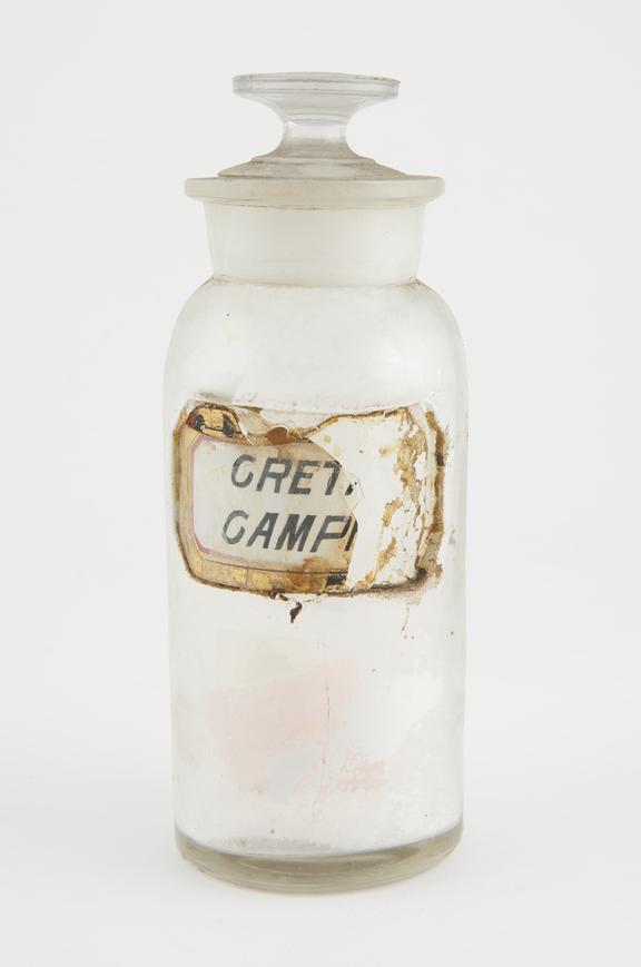 Bottle, clear glass, with contents, for camphorated chalk, USA