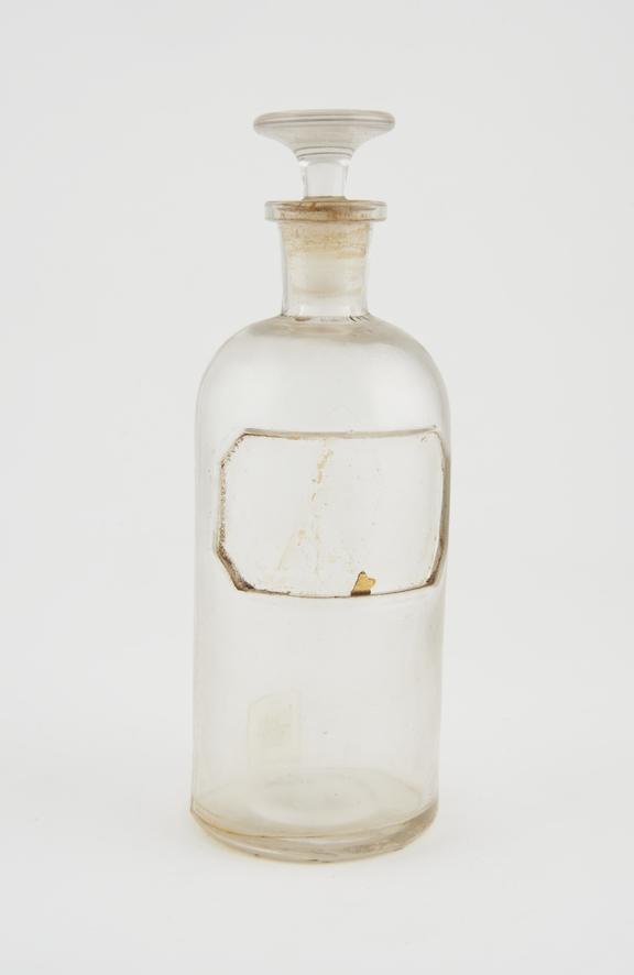 Bottle, clear glass, trace contents, label missing