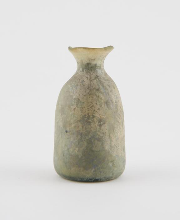 Dome shaped green glass bottle, iridescent