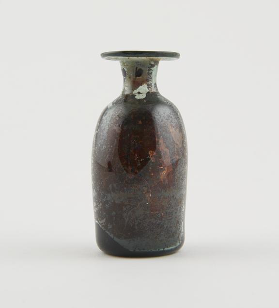 Pale green glass bottle with reddish brown stain inside