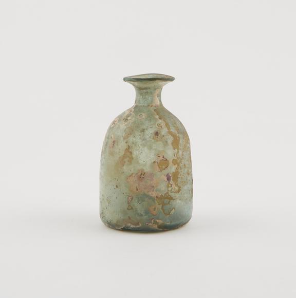 Pale green glass bottle, iridescent, bell shaped