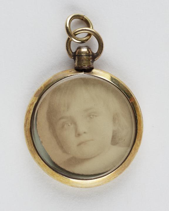 Small watch fob containing child's portrait