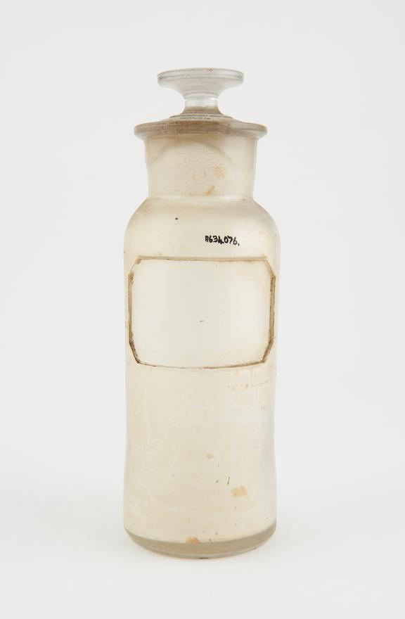 Bottle, clear glass, trace contents, label missing, USA