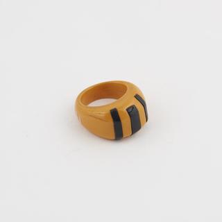Ring of orange catalin inset with three black stripes