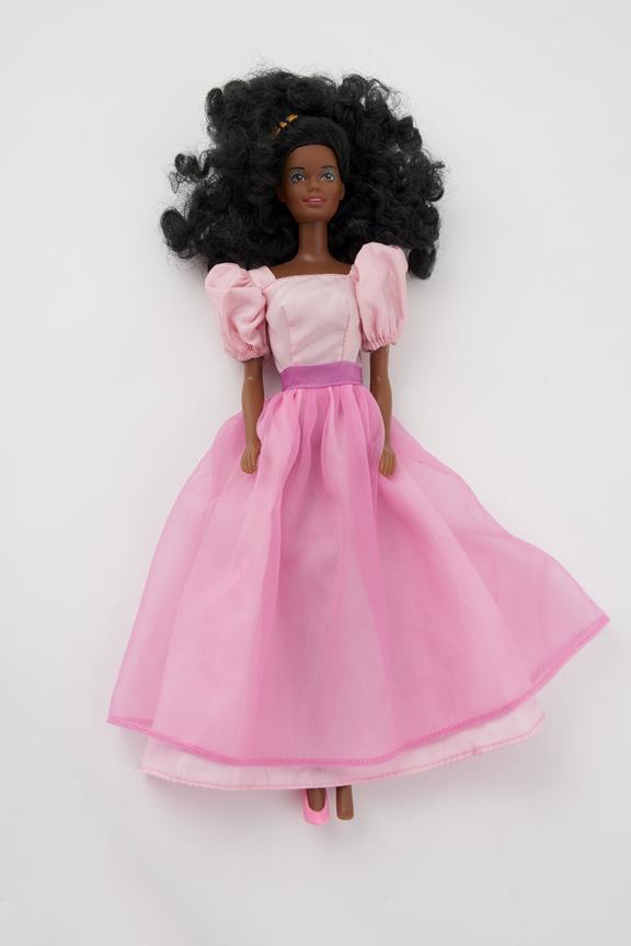 Black Barbie in long pink skirt,lighter pink top, purple belt