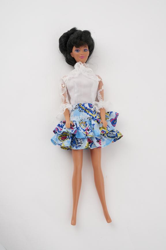 Brown Barbie in blue patterned skirt,white frilly blouse.