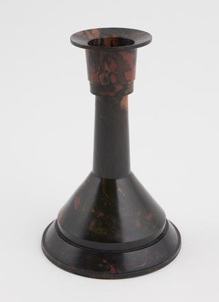 One of two phenolic brown mottled candlesticks