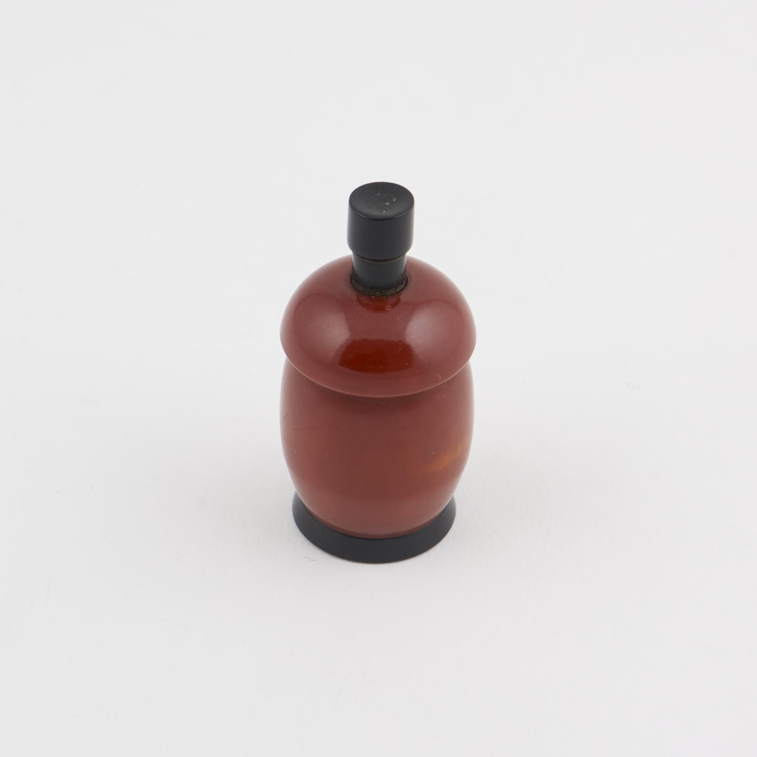One of two spring loaded salt/pepper pots