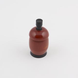 One of two spring loaded salt/pepper pots