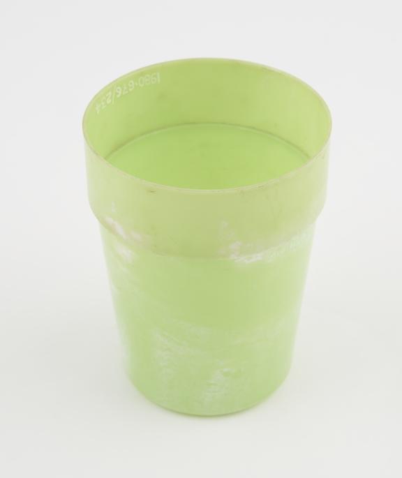 Circular beaker of apple green  marbled with white urea